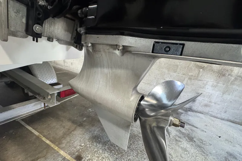 Slide: The Image of Close-up of a 1990 Skater 24 boat propeller and lower unit in a garage. - 20