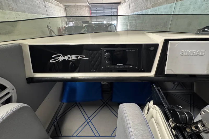 Slide: The Image of Interior of a 1990 Skater 24 boat with Simrad electronics and modern dashboard. - 28