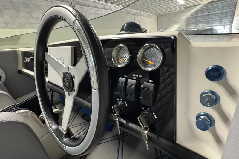 Slide: The Image of Interior of a 1990 Skater 24 boat showing steering wheel and dashboard controls. - 30