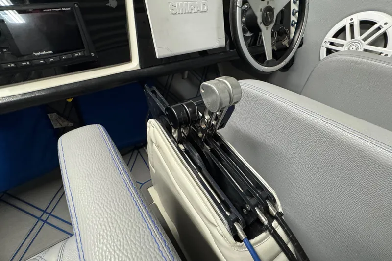 Slide: The Image of Interior of a 1990 Skater 24 boat with steering wheel and control panel. - 32