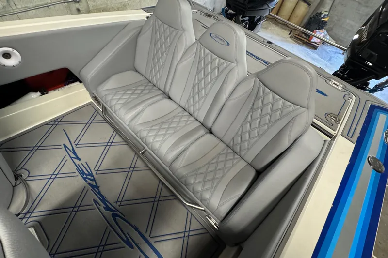 Slide: The Image of Gray leather seats in a 1990 Skater 24 boat interior, featuring diamond stitching. - 37