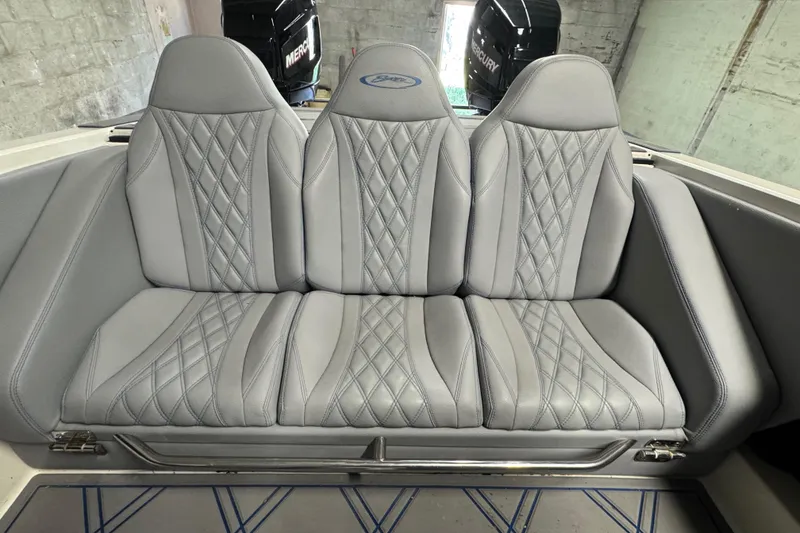 Slide: The Image of Gray leather boat seats with diamond stitching in a 1990 Skater 24 model. - 38