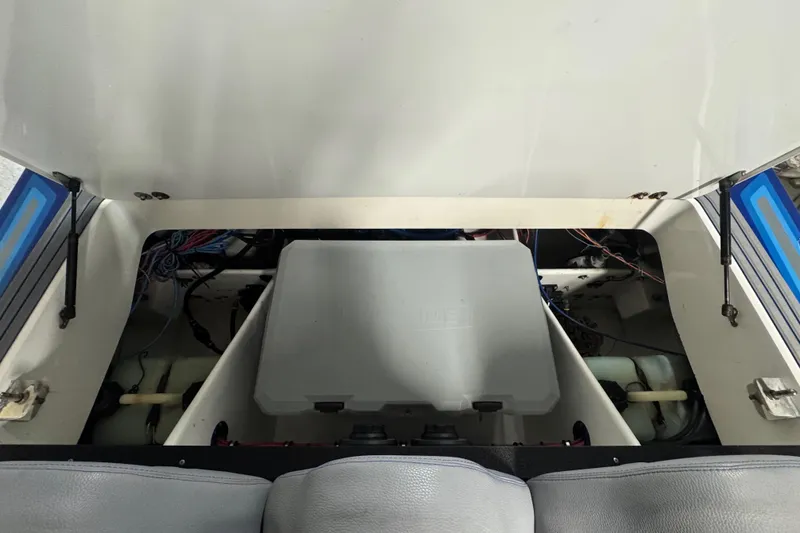 Slide: The Image of Open engine compartment of 1990 Skater 24 boat, showing wiring and components. - 42