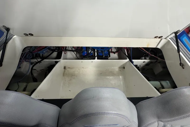 Slide: The Image of Interior view of a 1990 Skater 24 boat, showcasing wiring and seating. - 43