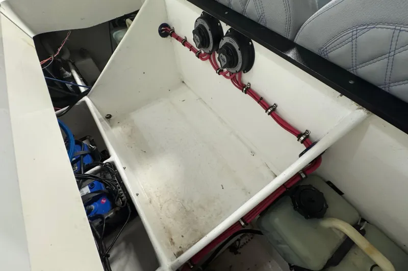 Slide: The Image of Interior view of a 1990 Skater 24 boat, showcasing wiring and components. - 44