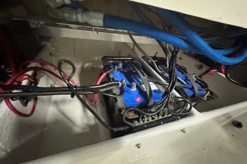 Slide: The Image of Battery compartment of a 1990 Skater 24 boat with wiring and connections. - 45