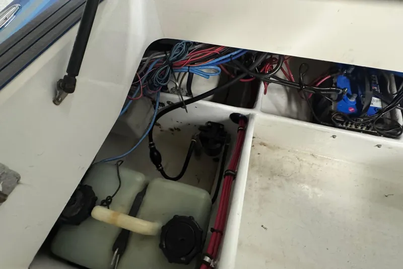 Slide: The Image of Interior view of a 1990 Skater 24 boat showing wiring and components. - 46