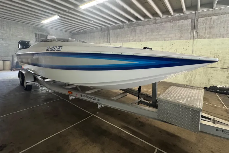 Slide: The Image of 1990 Skater 24 boat on trailer in indoor storage facility. - 5
