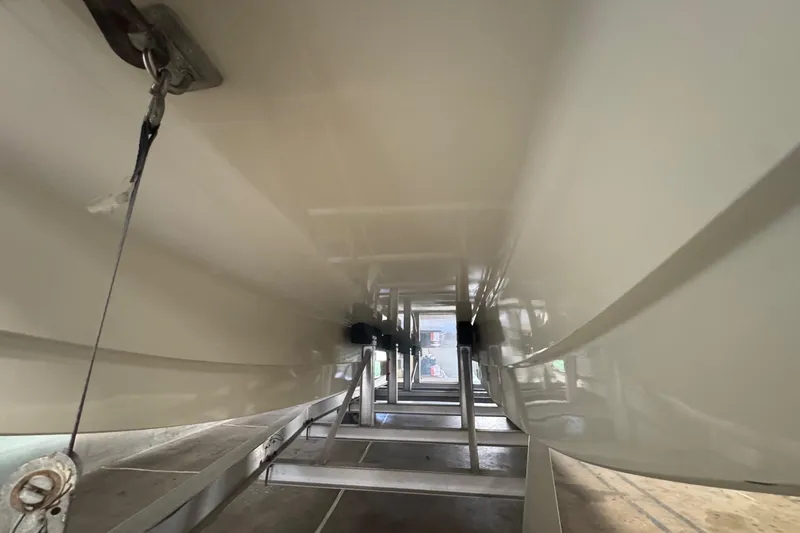 Slide: The Image of Underneath view of a 1990 Skater 24 boat hull on a trailer. - 9