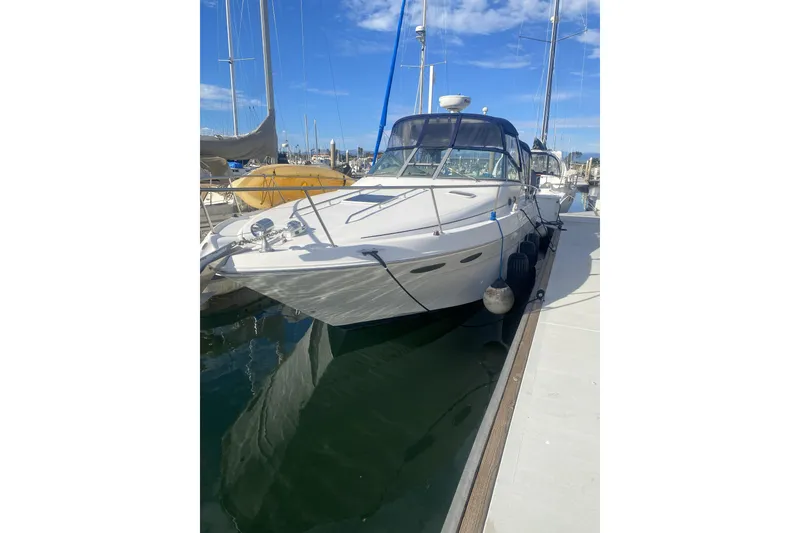 The Image of 1998 Searay Sundancer boat docked at marina under clear blue sky. - 1