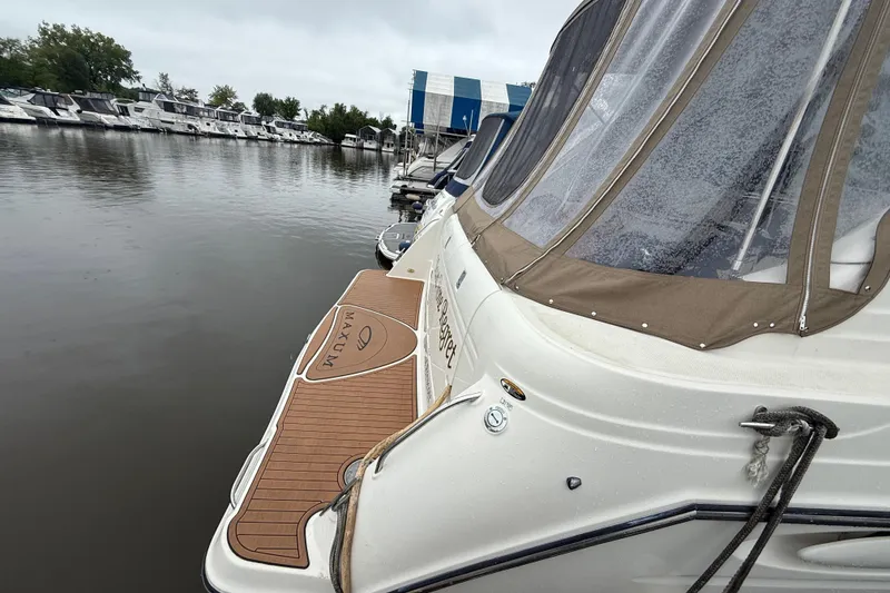 Slide: The Image of 2000 Maxum 3700 SCR boat docked at marina, featuring tan canopy and wooden deck. - 13