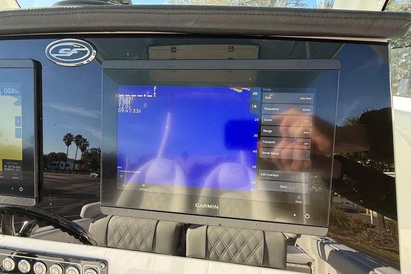 Slide: The Image of 2024 Sea Fox 288 Commander dashboard with Garmin sonar display and control settings. - 13