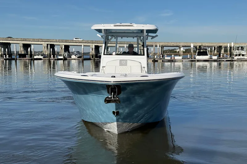 Slide: The Image of 2024 Sea Fox 288 Commander boat on calm water near a bridge. - 2