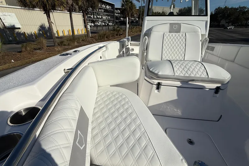 Slide: The Image of 2024 Sea Fox 288 Commander boat interior with white quilted seating and cup holders. - 25