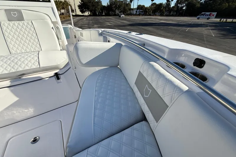 Slide: The Image of 2024 Sea Fox 288 Commander boat interior with white quilted seating and cup holders. - 26