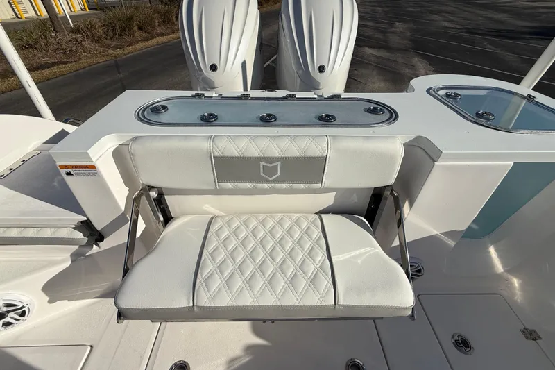 Slide: The Image of 2024 Sea Fox 288 Commander boat interior with cushioned seating and dual engines. - 29
