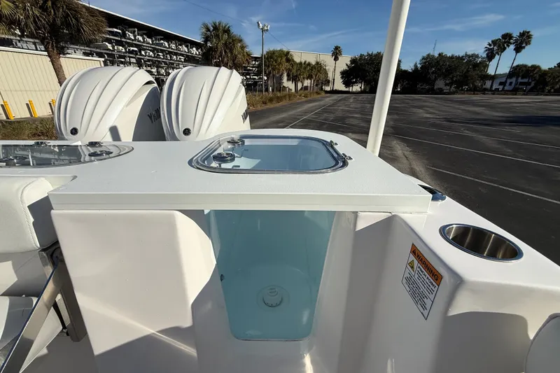 Slide: The Image of 2024 Sea Fox 288 Commander boat with dual Yamaha engines and livewell, parked outdoors. - 32