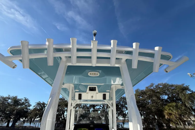 Slide: The Image of 2024 Sea Fox 288 Commander boat with rod holders and blue sky background. - 34