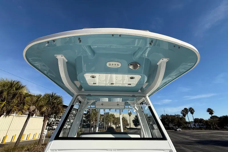 Slide: The Image of 2024 Sea Fox 288 Commander boat with blue T-top under clear sky. - 35