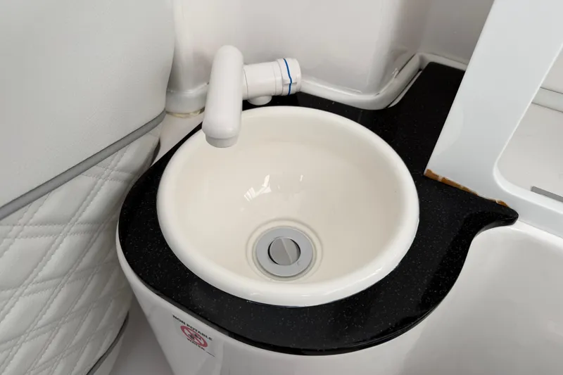 Slide: The Image of 2024 Sea Fox 288 Commander boat sink with white basin and black countertop. - 37