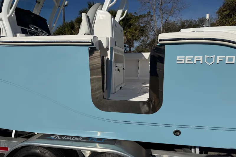 Slide: The Image of 2024 Sea Fox 288 Commander boat side view with open door, showcasing interior details. - 39
