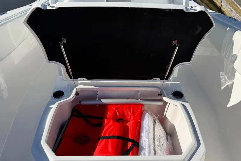 Slide: The Image of Open storage compartment on 2024 Sea Fox 288 Commander boat with safety gear inside. - 42