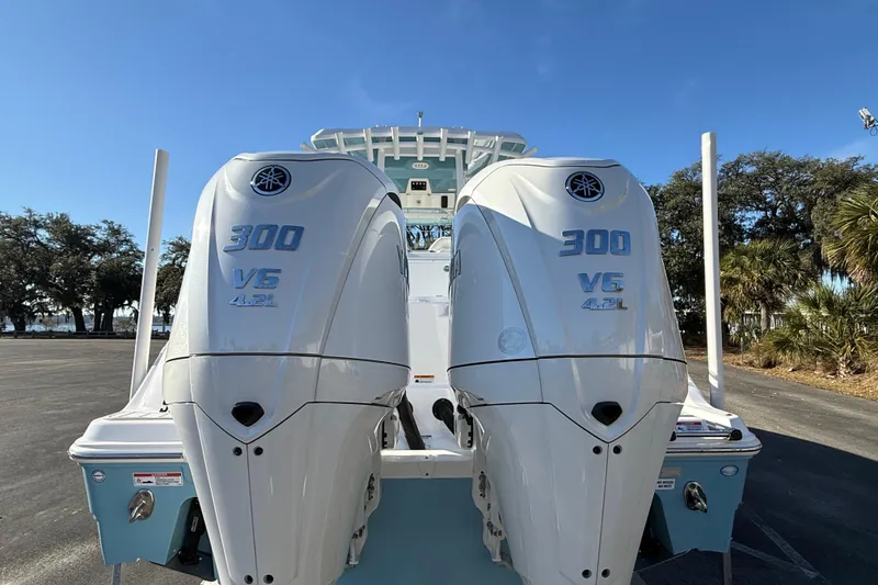 Slide: The Image of 2024 Sea Fox 288 Commander with twin 300 V6 engines, parked outdoors. - 8