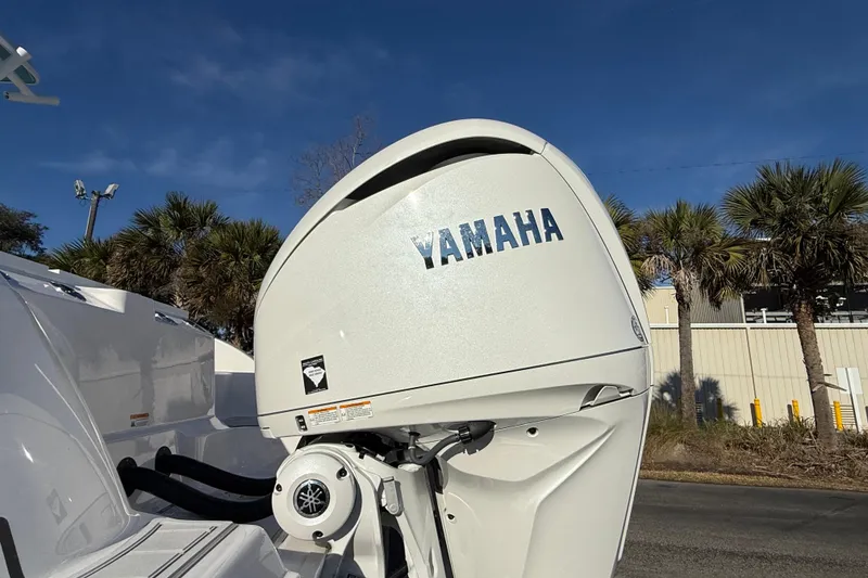 Slide: The Image of Yamaha outboard motor on 2024 Sea Fox 288 Commander boat, palm trees in background. - 9