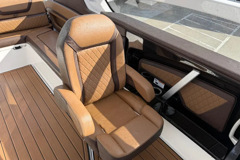 Slide: The Image of 2024 Yamaha 275SDX boat interior with luxurious brown leather seating and wood-style flooring. - 13