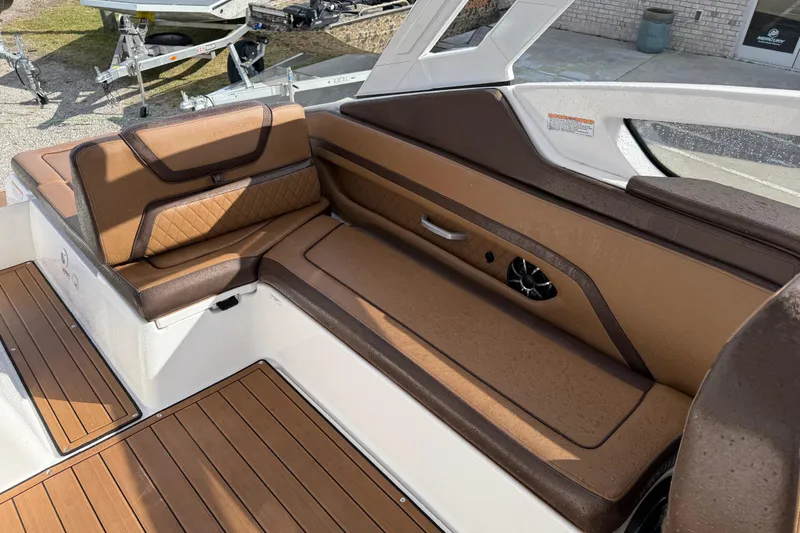 Slide: The Image of 2024 Yamaha 275SDX boat interior with brown leather seating and wood flooring. - 14