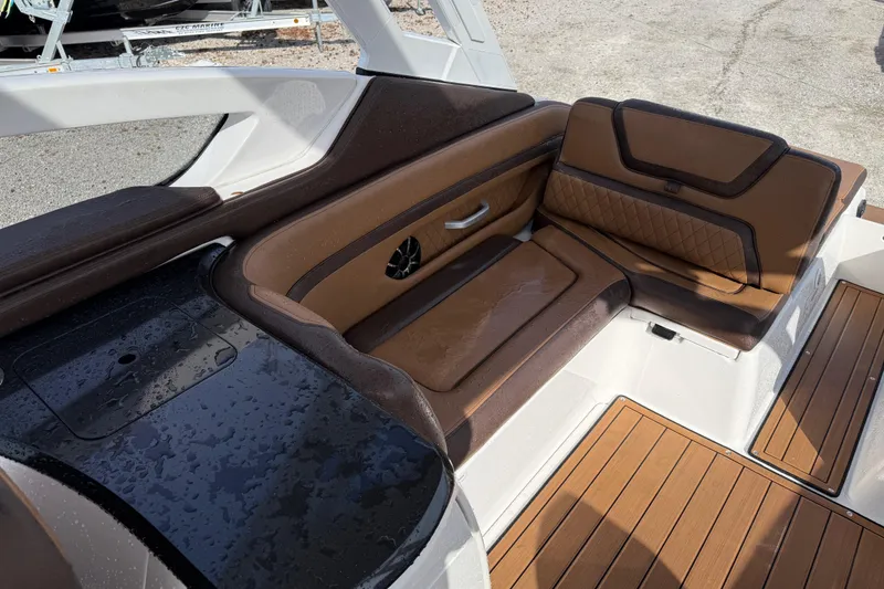 Slide: The Image of 2024 Yamaha 275SDX boat interior with brown leather seating and wood flooring. - 15