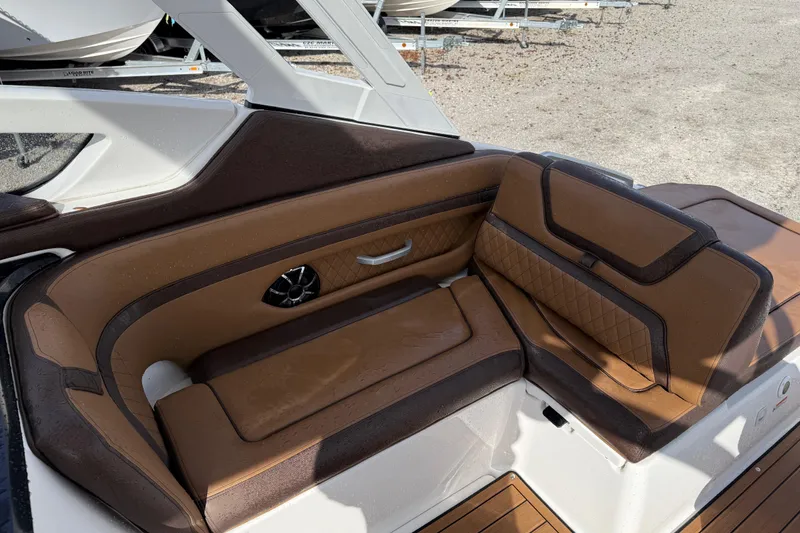 Slide: The Image of 2024 Yamaha 275SDX boat interior with brown leather seating and modern design. - 16
