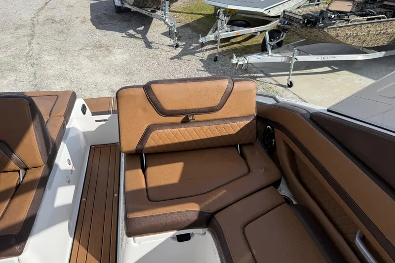Slide: The Image of 2024 Yamaha 275SDX boat interior with brown leather seating and wood flooring. - 18
