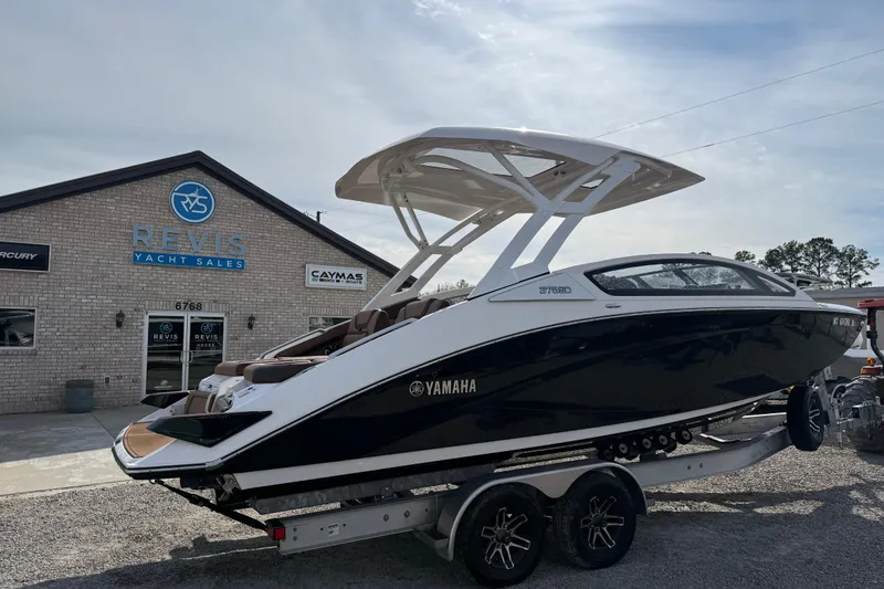 Slide: The Image of 2024 Yamaha 275SDX boat on trailer at Revis Yacht Sales dealership. - 3