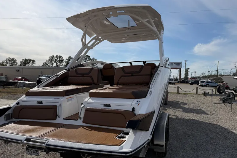Slide: The Image of 2024 Yamaha 275SDX boat with sleek design and luxurious seating on display outdoors. - 5