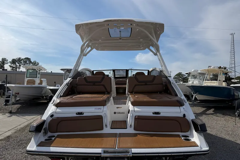 Slide: The Image of 2024 Yamaha 275SDX boat with luxurious seating and sleek design, displayed outdoors. - 6