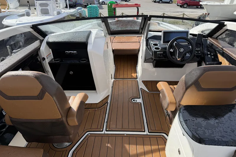 Slide: The Image of 2024 Yamaha 275SDX boat interior with modern dashboard and seating. - 9
