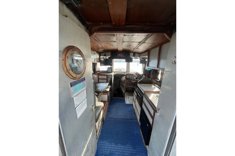 Slide: The Image of Interior of a 1992 Munson 38’ Aluminum Commercial Dive boat, featuring a compact cabin layout. - 3