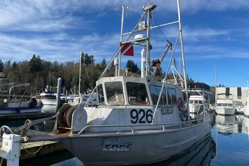 Slide: The Image of 1992 Munson 38’ Aluminum Commercial Dive boat docked in a marina under clear blue skies. - 5