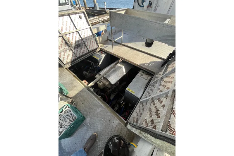 Slide: The Image of 1992 Munson 38’ Aluminum Commercial Dive boat engine compartment open for maintenance. - 6