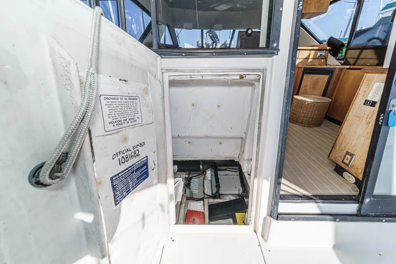 Slide: The Image of 1998 Bayliner 3988 Motoryacht interior with open hatch and visible storage area. - 10