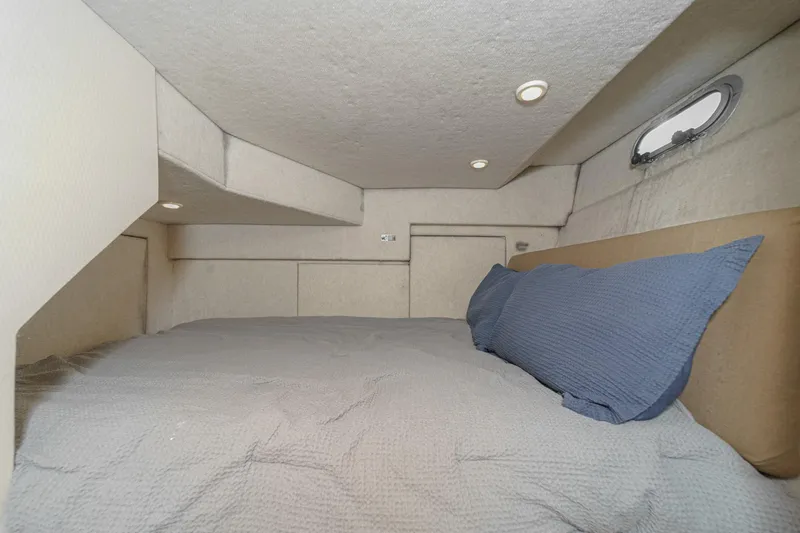 Slide: The Image of Cozy cabin interior of 1998 Bayliner 3988 Motoryacht with bed and porthole. - 12