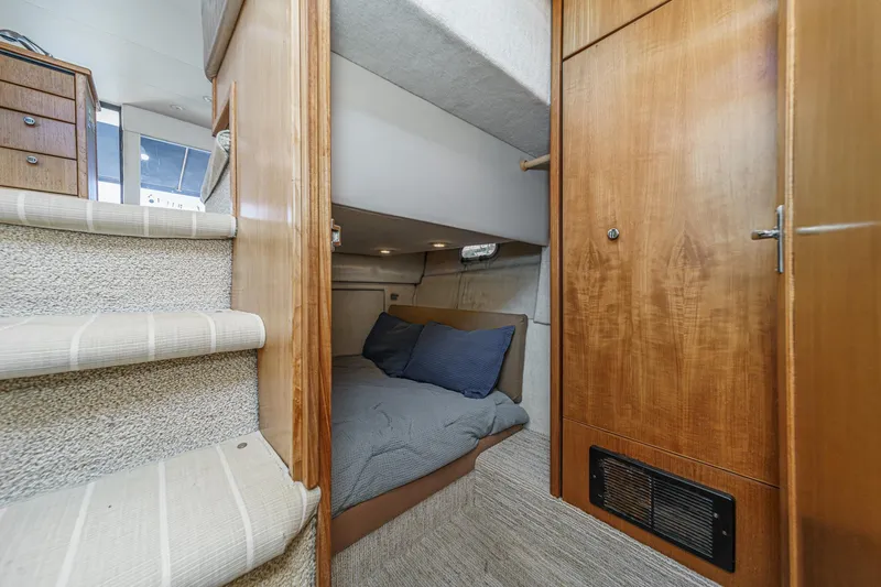 Slide: The Image of 1998 Bayliner 3988 Motoryacht interior cabin with cozy bed and wooden cabinetry. - 13