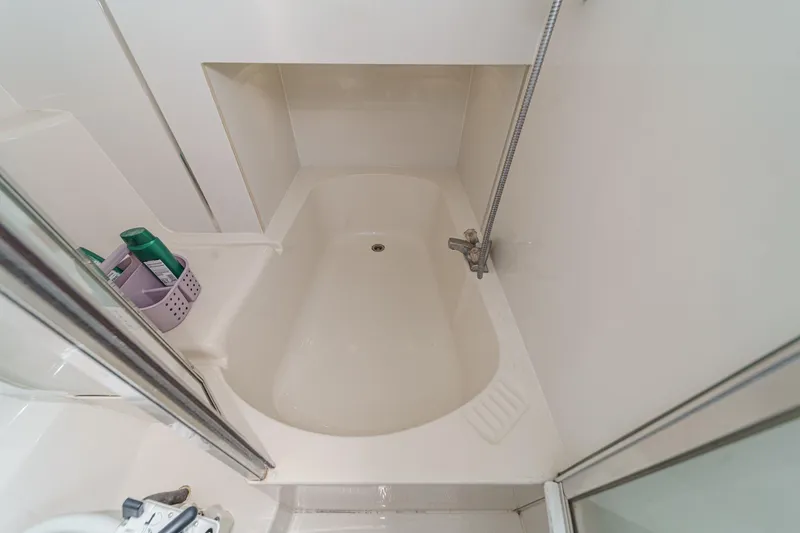 Slide: The Image of 1998 Bayliner 3988 Motoryacht bathroom with compact bathtub and showerhead. - 15