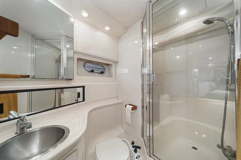 Slide: The Image of 1998 Bayliner 3988 Motoryacht bathroom with shower, sink, and mirror. - 17