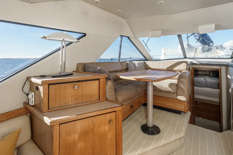 Slide: The Image of Interior of 1998 Bayliner 3988 Motoryacht with cozy seating and wooden cabinetry. - 22
