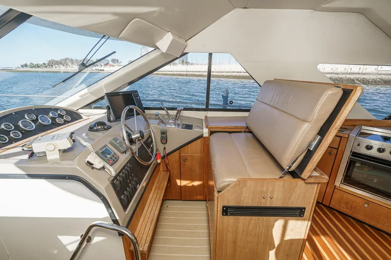 Slide: The Image of 1998 Bayliner 3988 Motoryacht interior with helm, seating, and kitchen area. - 27