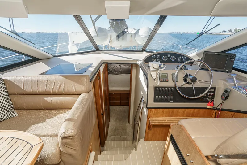 Slide: The Image of 1998 Bayliner 3988 Motoryacht interior with helm, seating, and ocean view. - 28