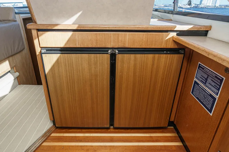 Slide: The Image of 1998 Bayliner 3988 Motoryacht interior with wooden cabinetry and flooring. - 29