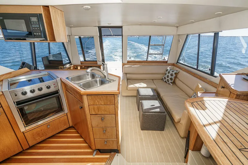 Slide: The Image of Interior of 1998 Bayliner 3988 Motoryacht with kitchen, seating, and ocean view. - 3